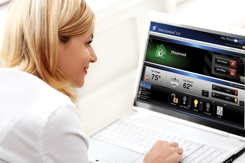 woman on laptop viewing security system app
