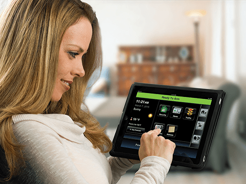 woman viewing security app on tablet