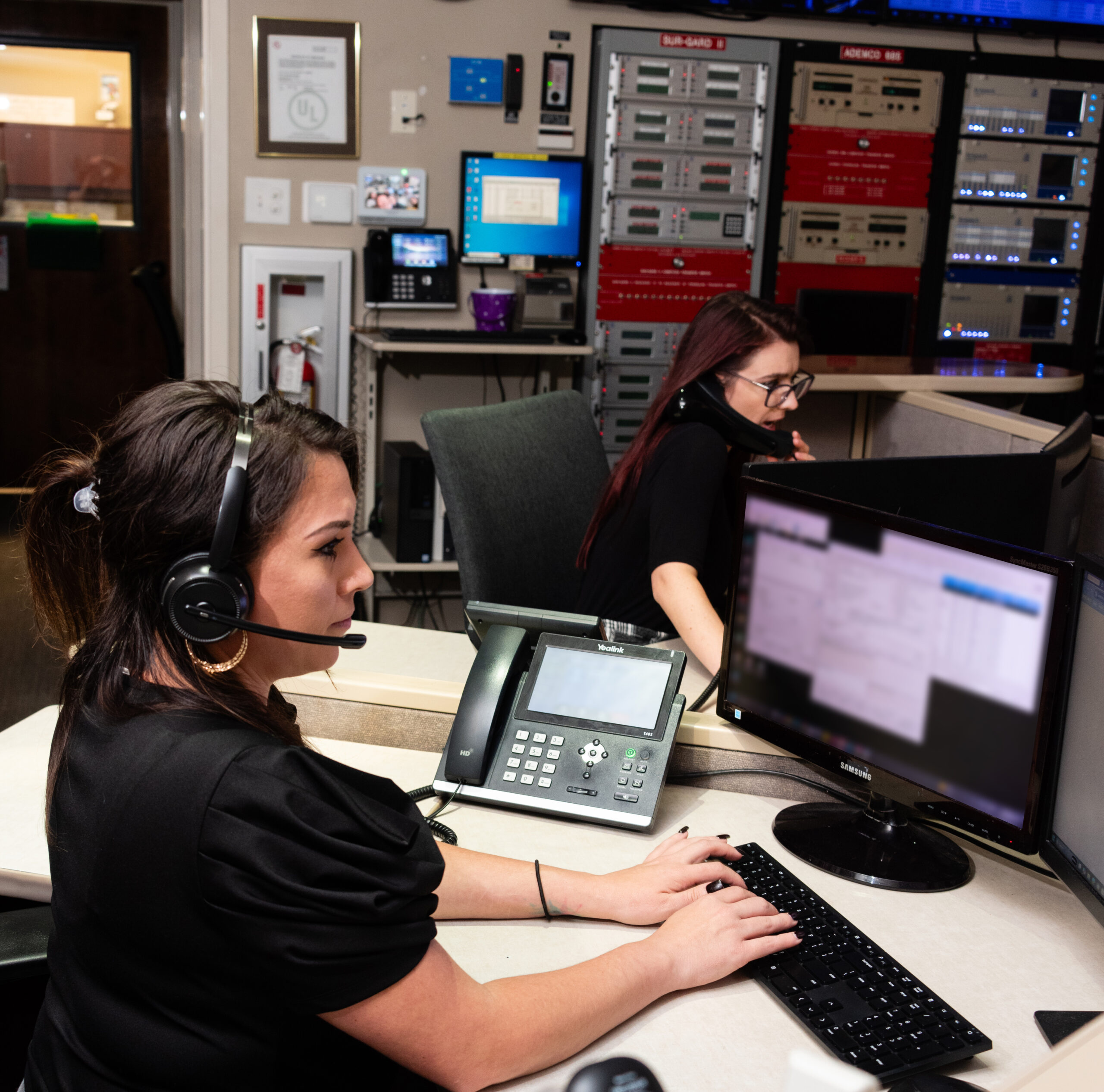 Women working at Custom Security Systems 24/7 monitoring station