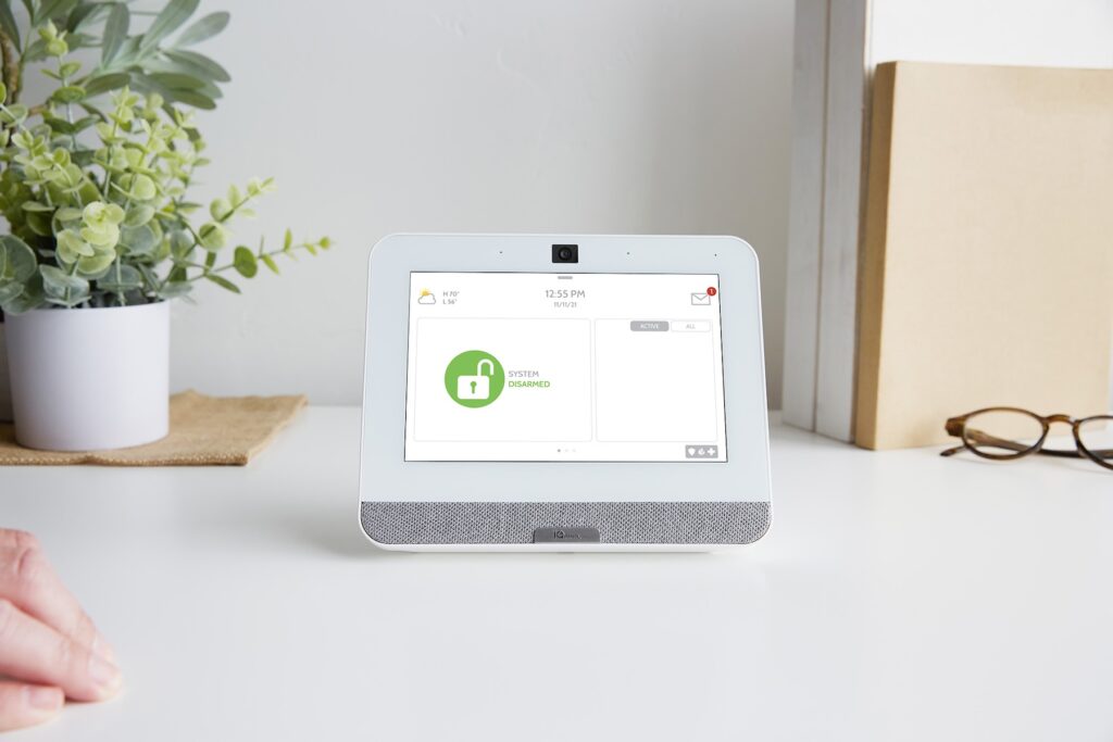 Security panel on kitchen counter next to potted plant