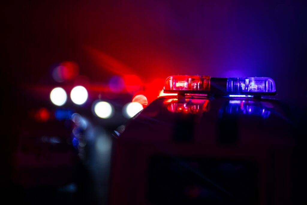Close up of blue and red lights on a police car at night.